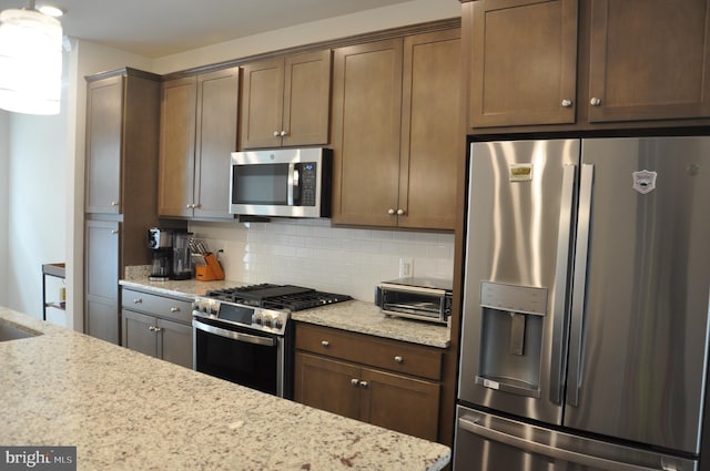 16150 Bowery St, Rockville, MD 20855 - kitchen with stainless steel appliances, tasteful backsplash, and light stone countertops