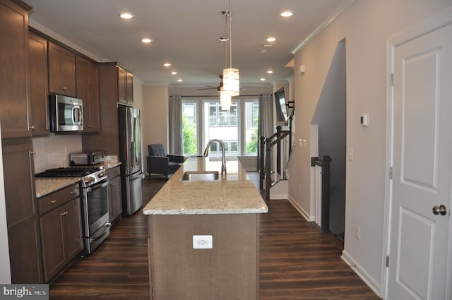 16150 Bowery St, Rockville, MD 20855 - kitchen with stainless steel appliances, a sink, ornamental molding, a center island with sink, and dark wood-type flooring