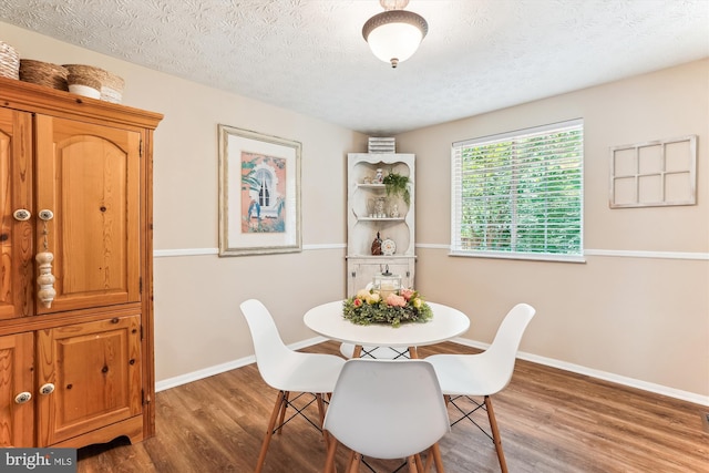 1646 Sierra Woods Dr, Reston, VA 20194 - dining space featuring wood finished floors, baseboards, and a textured ceiling