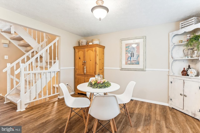 1646 Sierra Woods Dr, Reston, VA 20194 - dining room featuring wood finished floors, stairs, baseboards, and a textured ceiling