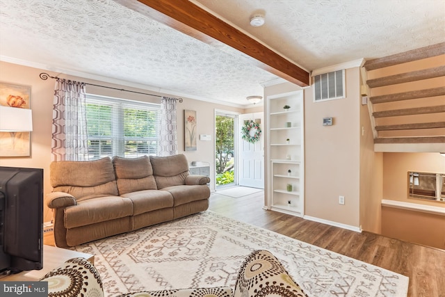 1646 Sierra Woods Dr, Reston, VA 20194 - living area featuring wood finished floors, crown molding, a textured ceiling, baseboards, and beamed ceiling