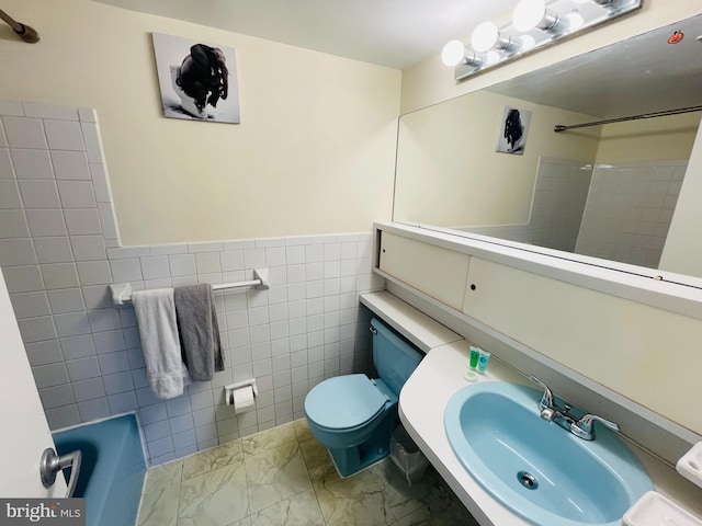 46 Township Line Rd Unit 215, Elkins Park, PA 19027 - bathroom featuring marble look tile flooring, a sink, toilet, a shower, and a bathtub