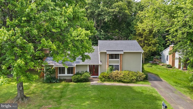 402 Sugarland Run Dr, Sterling, VA 20164 - traditional-style house featuring a shingled roof, a front yard, asphalt driveway, and brick siding