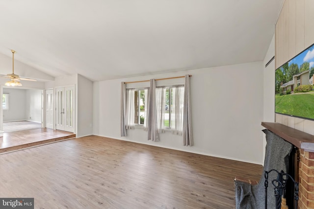 402 Sugarland Run Dr, Sterling, VA 20164 - unfurnished living room featuring vaulted ceiling, plenty of natural light, wood finished floors, and ceiling fan