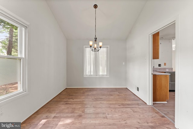 402 Sugarland Run Dr, Sterling, VA 20164 - unfurnished dining area with plenty of natural light, vaulted ceiling, a chandelier, and light wood-type flooring