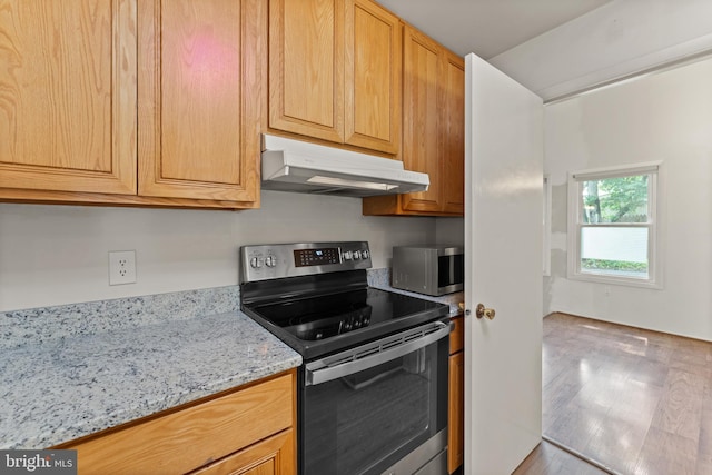 402 Sugarland Run Dr, Sterling, VA 20164 - kitchen featuring electric range oven, under cabinet range hood, stainless steel microwave, light stone counters, and wood finished floors