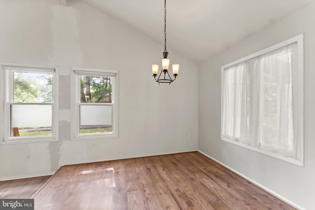 402 Sugarland Run Dr, Sterling, VA 20164 - unfurnished dining area featuring lofted ceiling, a chandelier, and wood finished floors