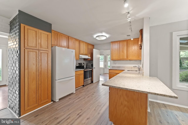 402 Sugarland Run Dr, Sterling, VA 20164 - kitchen with freestanding refrigerator, stainless steel electric range, a peninsula, rail lighting, and light wood-style flooring