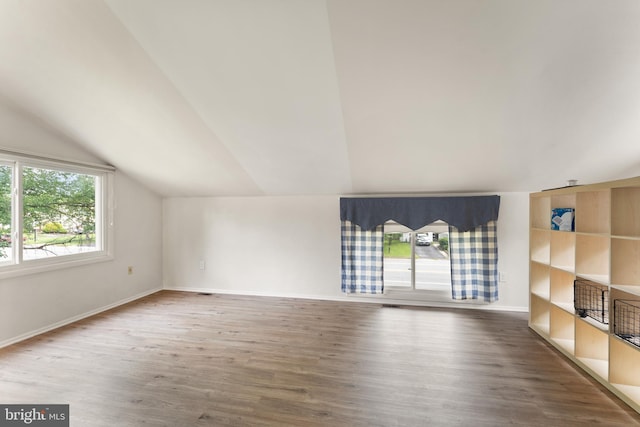 402 Sugarland Run Dr, Sterling, VA 20164 - unfurnished living room featuring plenty of natural light, vaulted ceiling, and wood finished floors