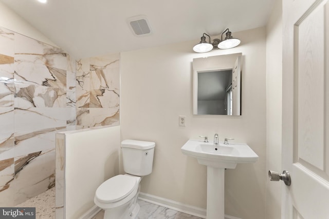 402 Sugarland Run Dr, Sterling, VA 20164 - bathroom featuring a marble finish shower and marble look tiles