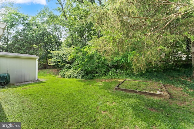 402 Sugarland Run Dr, Sterling, VA 20164 - view of grassy yard featuring a garden and an outbuilding