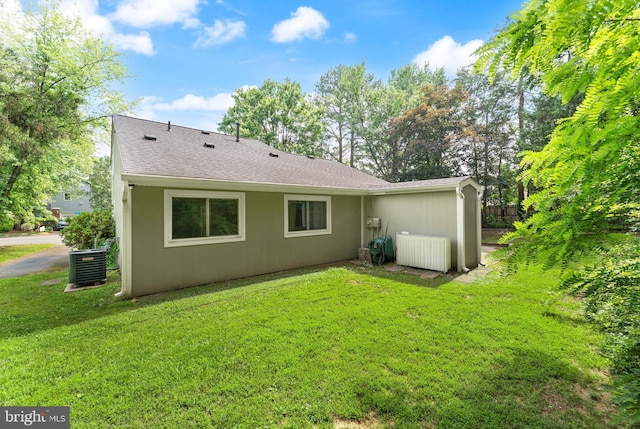 402 Sugarland Run Dr, Sterling, VA 20164 - back of house with a lawn and roof with shingles