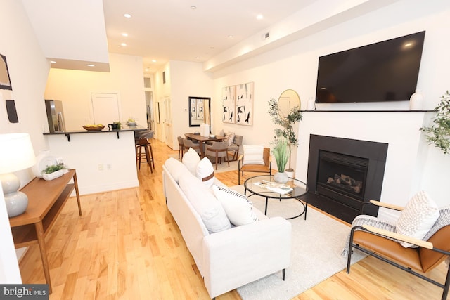 1622 19th St NW Unit 2, Washington, DC 20009 - living area with light wood-style floors, recessed lighting, and a fireplace with flush hearth