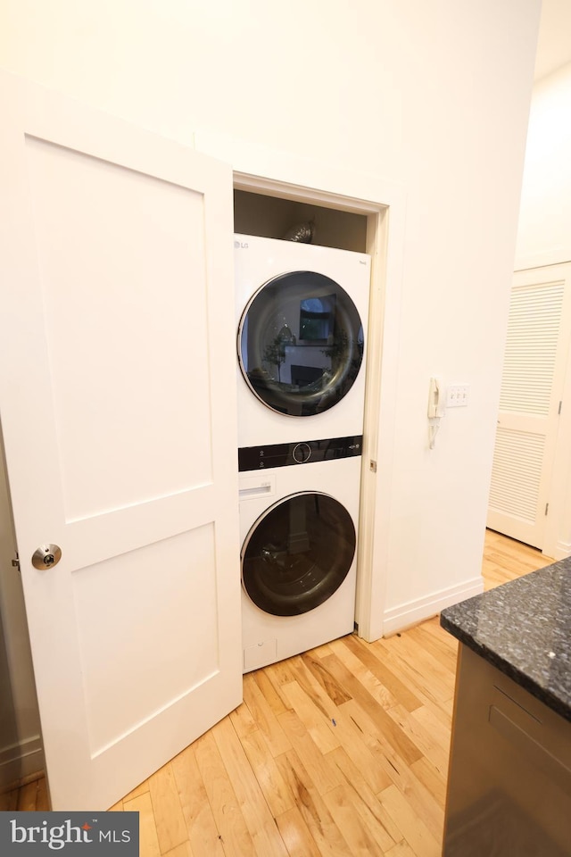 1622 19th St NW Unit 2, Washington, DC 20009 - laundry room with stacked washer / drying machine and light wood-style flooring