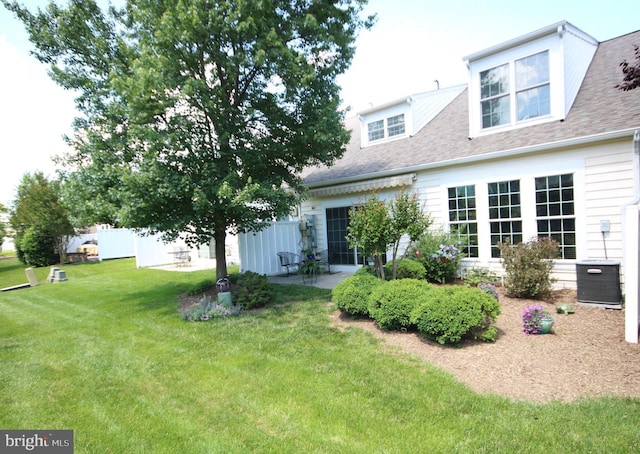 44497 Maltese Falcon Sq, Ashburn, VA 20147 - back of property with a yard, roof with shingles, and a patio
