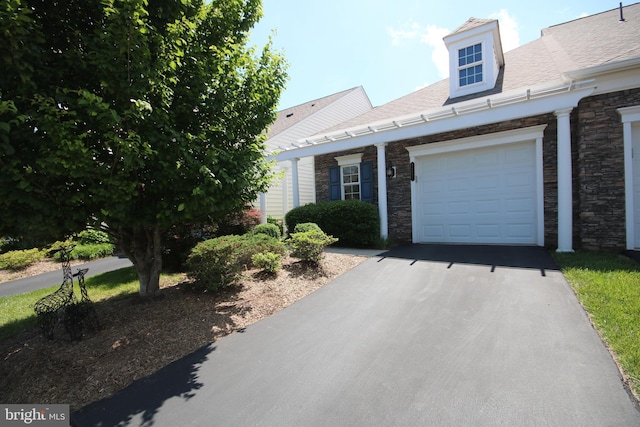 44497 Maltese Falcon Sq, Ashburn, VA 20147 - view of front facade with stone siding, asphalt driveway, and an attached garage