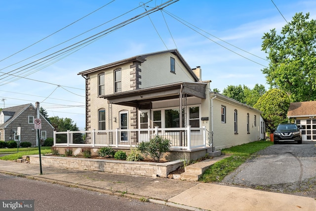 253 Elm St, Pottstown, PA 19464 - view of front facade featuring a porch, brick siding, and a chimney