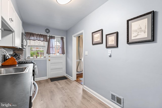 222 Blakeney Rd, Baltimore, MD 21228 - laundry area featuring light wood-style floors and baseboards