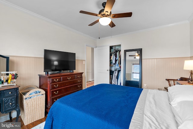 222 Blakeney Rd, Baltimore, MD 21228 - bedroom featuring a wainscoted wall, crown molding, ceiling fan, wood finished floors, and a closet