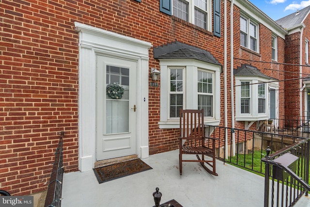 222 Blakeney Rd, Baltimore, MD 21228 - doorway to property featuring brick siding