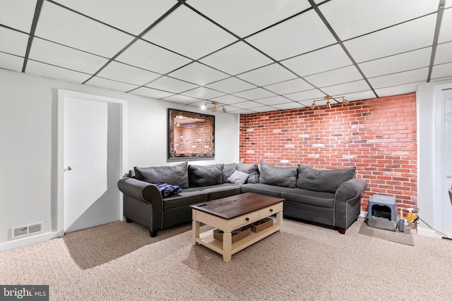 222 Blakeney Rd, Baltimore, MD 21228 - carpeted living area with a drop ceiling and brick wall
