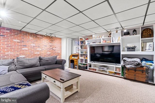 222 Blakeney Rd, Baltimore, MD 21228 - carpeted living area featuring brick wall and a paneled ceiling