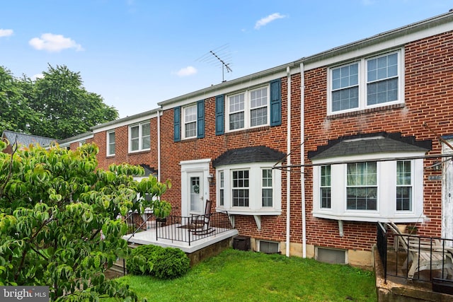 222 Blakeney Rd, Baltimore, MD 21228 - view of front of home with brick siding and a front yard