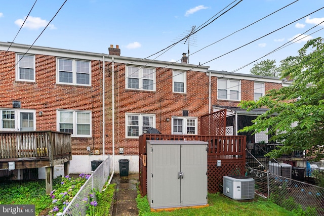 222 Blakeney Rd, Baltimore, MD 21228 - back of property with a chimney, brick siding, a wooden deck, and a shed