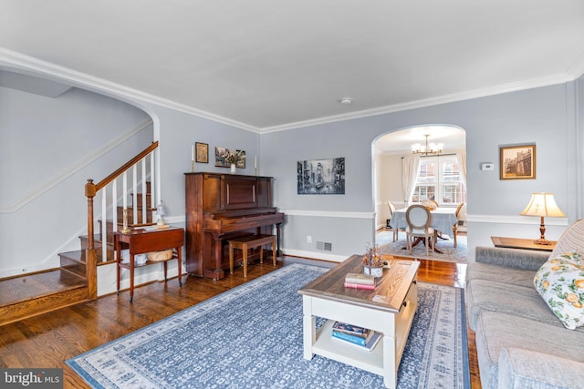 222 Blakeney Rd, Baltimore, MD 21228 - living room featuring arched walkways, wood finished floors, stairs, a chandelier, and ornamental molding