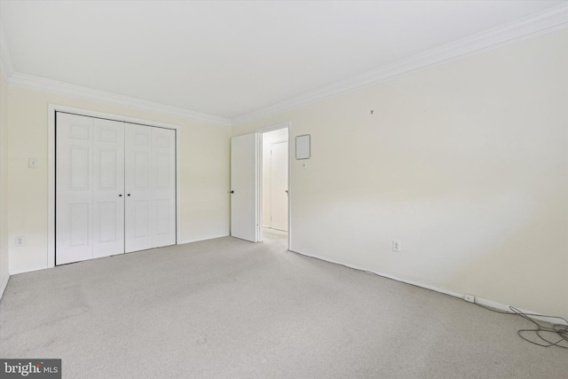 48 Llanfair Rd Unit 1, Ardmore, PA 19003 - unfurnished bedroom featuring light colored carpet, crown molding, and a closet