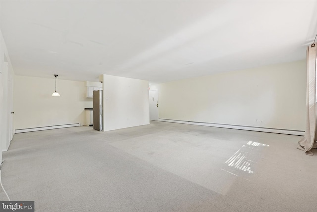 48 Llanfair Rd Unit 1, Ardmore, PA 19003 - unfurnished living room featuring a baseboard heating unit and light colored carpet