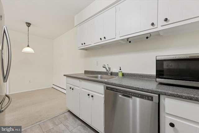 48 Llanfair Rd Unit 1, Ardmore, PA 19003 - kitchen with stainless steel appliances, light carpet, baseboard heating, dark countertops, and white cabinets