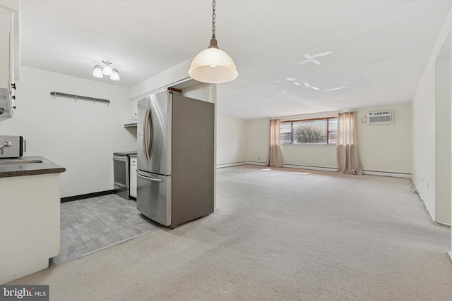 48 Llanfair Rd Unit 1, Ardmore, PA 19003 - kitchen with stainless steel appliances, white cabinets, dark countertops, a wall mounted AC, and light colored carpet
