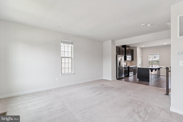8330 Graham Patrick Ave, Brandywine, MD 20613 - unfurnished living room featuring dark colored carpet and recessed lighting