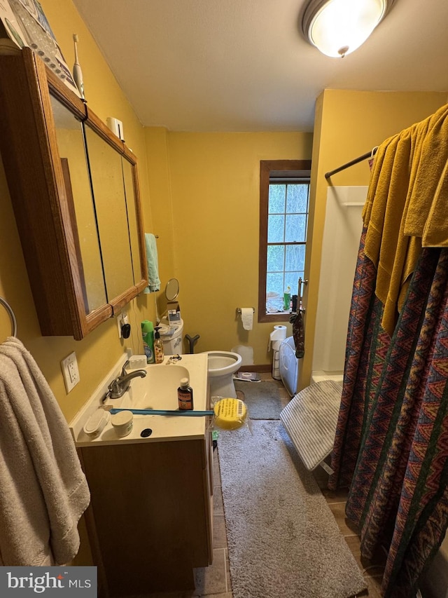 3236 George St, Baltimore, MD 21220 - bathroom with vanity, toilet, and baseboards