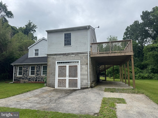 3236 George St, Baltimore, MD 21220 - back of house featuring a wooden deck, a yard, a carport, and stone siding