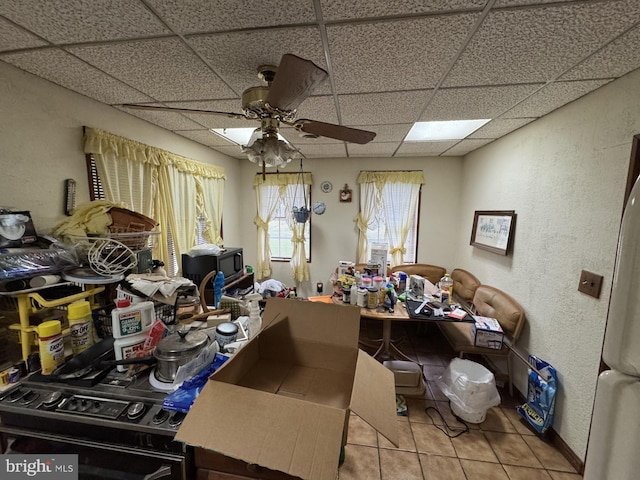 3236 George St, Baltimore, MD 21220 - misc room featuring a drop ceiling, ceiling fan, tile patterned flooring, and a textured wall