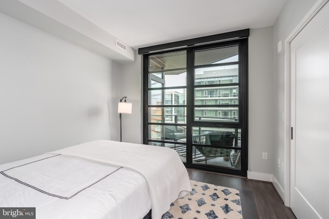 1300 4th St SE Unit 715, Washington, DC 20003 - bedroom featuring dark wood finished floors and expansive windows