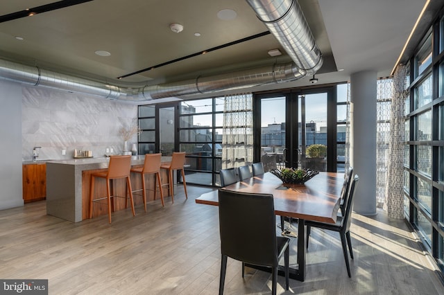 1300 4th St SE Unit 715, Washington, DC 20003 - dining room featuring french doors, plenty of natural light, light wood finished floors, and a wall of windows