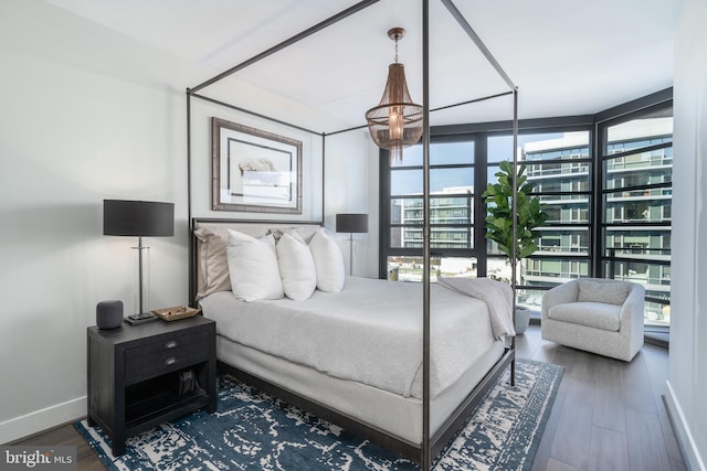 1300 4th St SE Unit 715, Washington, DC 20003 - bedroom featuring multiple windows, wood finished floors, and floor to ceiling windows