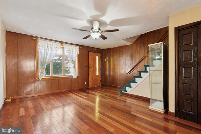 5450 Erdrick St, Philadelphia, PA 19124 - foyer entrance featuring stairs, a ceiling fan, wood walls, and hardwood / wood-style flooring