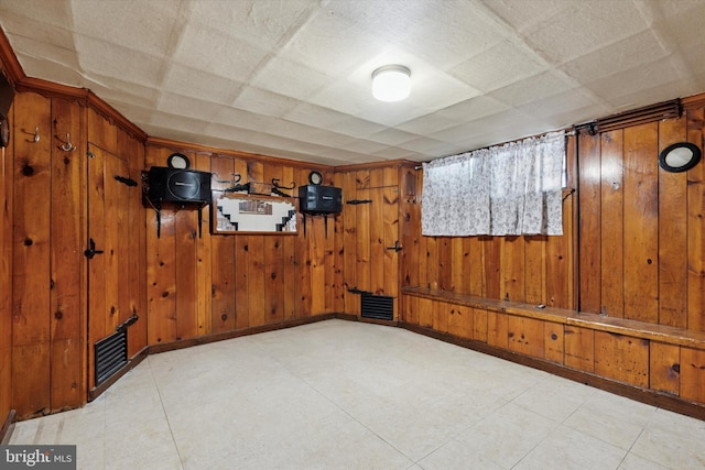 5450 Erdrick St, Philadelphia, PA 19124 - unfurnished room with wood walls and tile patterned floors