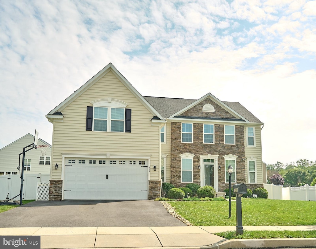 1003 Cedarbrook Ln, Pennsburg, PA 18073 - view of front of home with stone siding, asphalt driveway, and an attached garage