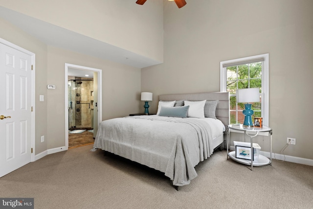 8878 Ashgrove House Ln, Vienna, VA 22182 - carpeted bedroom featuring baseboards, a towering ceiling, connected bathroom, and a ceiling fan