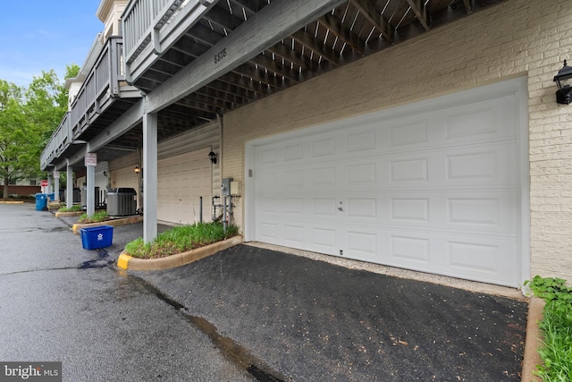 8878 Ashgrove House Ln, Vienna, VA 22182 - garage with driveway and central AC