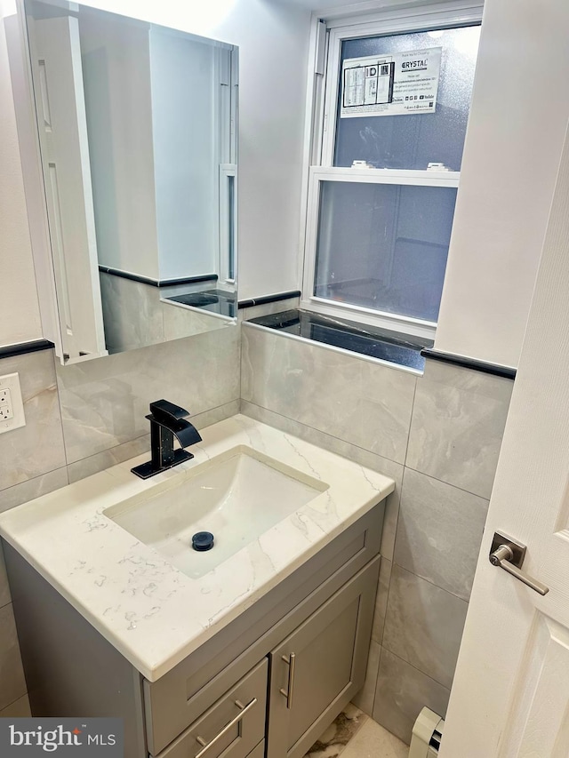 205 W Wishart St, Philadelphia, PA 19133 - bathroom with tile walls, vanity, and a baseboard radiator