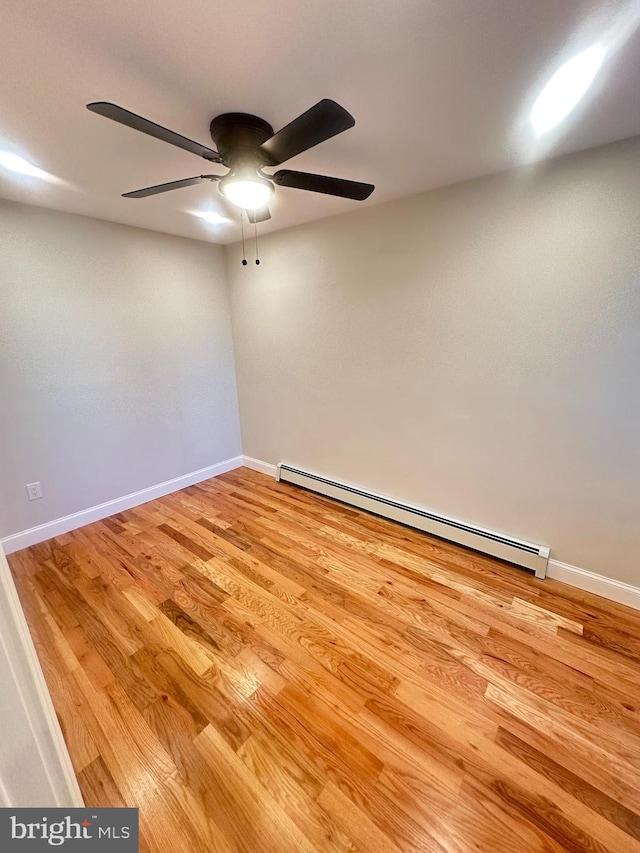 205 W Wishart St, Philadelphia, PA 19133 - spare room featuring baseboard heating, a ceiling fan, light wood-style floors, and baseboards