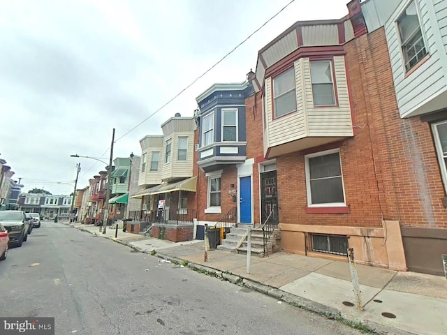 2828 N Stillman St, Philadelphia, PA 19132 - view of asphalt street featuring sidewalks, a residential view, street lighting, and curbs
