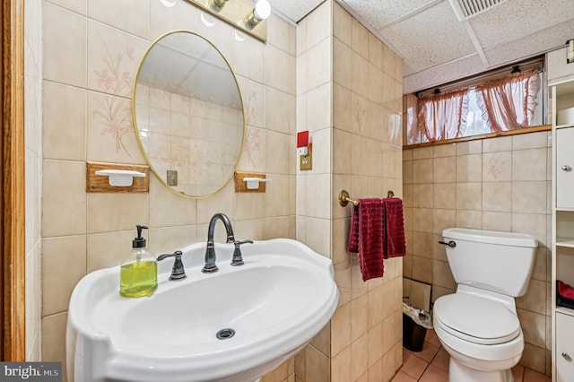 110 S Marlyn Ave, Essex, MD 21221 - half bathroom featuring tile walls, a paneled ceiling, and tile patterned floors