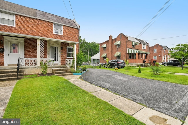 110 S Marlyn Ave, Essex, MD 21221 - view of front of property featuring brick siding, a front lawn, and a porch